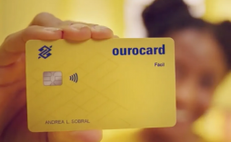 uma mulher segurando o cartão ourocard fácil
